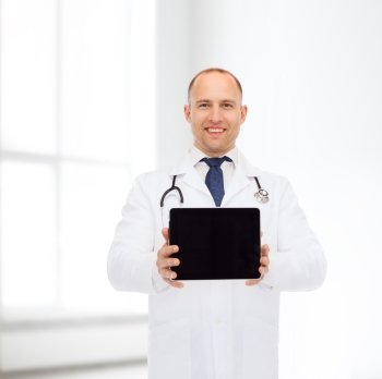 medicine, advertisement and teamwork concept - smiling male doctor with stethoscope showing tablet pc computer screen over blue background