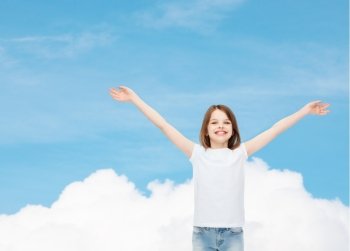 advertising, dream, childhood, gesture and people - smiling little girl in white t-shirt with stretched out arms over blue sky background