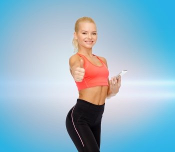 sport, fitness, technology, internet and healthcare concept - smiling sporty woman with smartphone showing thumbs up