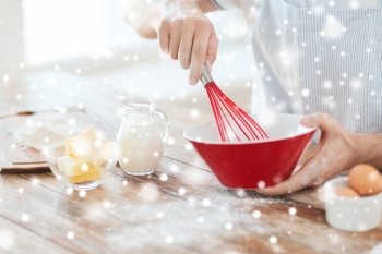 cooking, food, people and home concept - close up of man whipping eggs or cream with whisk in bowl