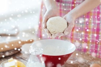 cooking and home concept - close up of female hands kneading dough at home