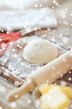 cooking, baking and home concept - close up of bread dough and utensils on cutting board
