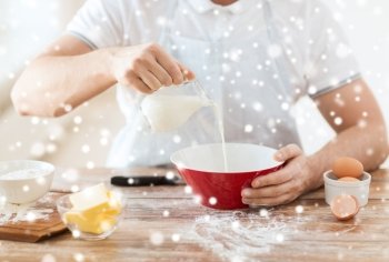 cooking, food, people and home concept - close up of man pouring milk into bowl and other ingredients
