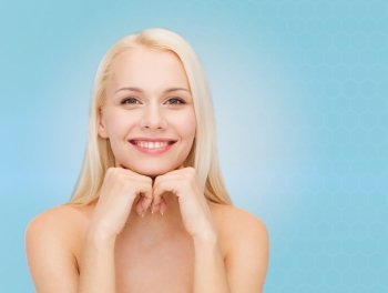 beauty, people and health concept - beautiful young woman with bare shoulders over blue background