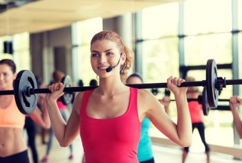 fitness, sport, training, gym and lifestyle concept - group of women with barbells in gym
