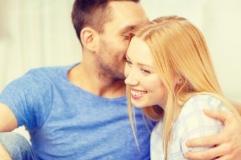 love, family and happiness concept - man kissing young woman at home