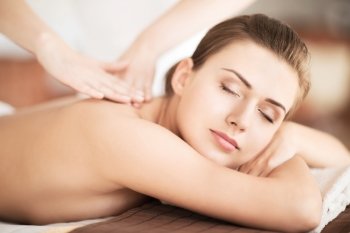 beauty and spa concept - beautiful woman in spa salon getting massage
