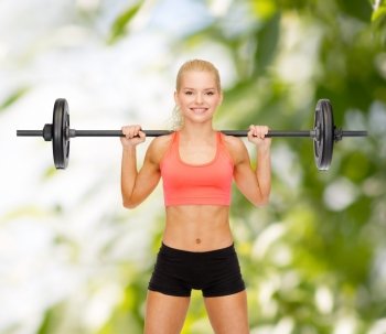 fitness, sport and dieting concept - smiling sporty woman exercising with barbell