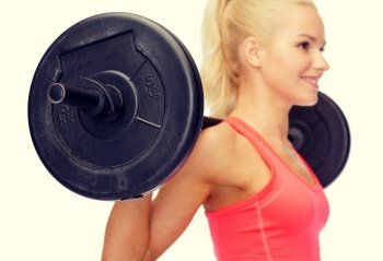 fitness, sport and dieting concept - smiling sporty woman exercising, focus on barbell