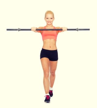fitness, sport and dieting concept - smiling sporty woman with barbell stepping forward