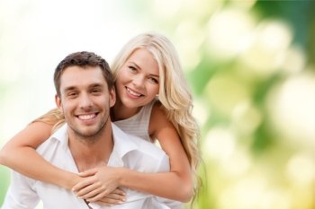 summer holiday, vacation, dating and love concept - happy couple having fun over green background