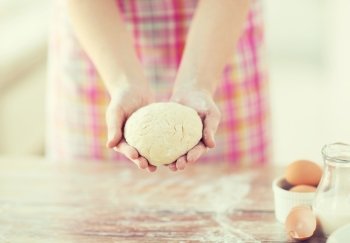 cooling and home concept - close up of female hands holding bread dough