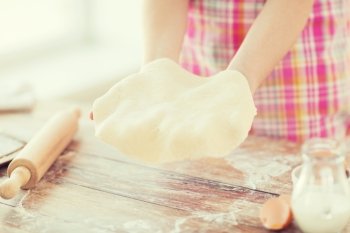cooling and home concept - close up of female hands holding bread dough