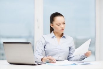 business, technology, internet and office concept - busy, businesswoman with laptop and charts in office