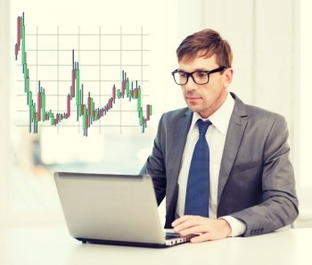 technology, money, business and office concept - handsome businessman in black eyeglasses with laptop computer and forex chart