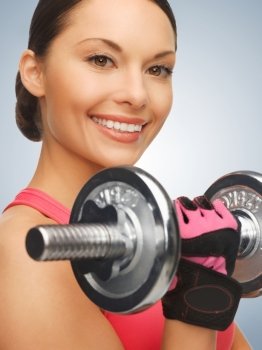 picture of beautiful sporty woman with dumbbell