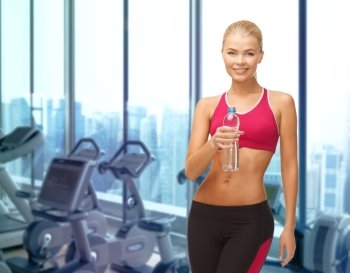 people, sport, fitness and recreation concept - happy woman with bottle of water over gym machines background
