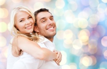 summer holidays, dating, love, romance and people concept - happy couple hugging fun over blue holidays lights background
