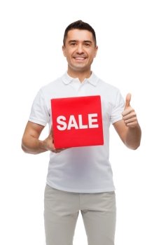 shopping, discount, consumerism, gesture and people concept - smiling man with red sale sigh showing thumbs up