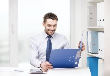 business, office and technology concept - smiling businessman with folder and tablet pc computer at office