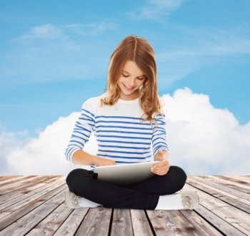 education, technology, childhood and people concept - happy little student girl with tablet pc over blue sky and cloud background