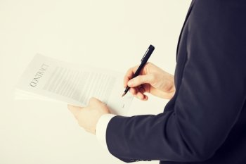 picture of man hands signing contract with random text