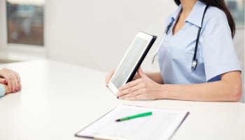 medicine, health and hospital concept - close up of female doctor showing to patient x-ray of spine on tablet pc computer screen