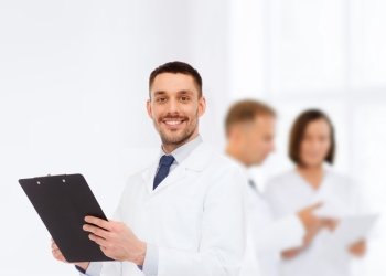 medicine, profession, and healthcare concept - smiling male doctor with clipboard writing prescription over white background