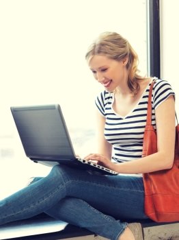 picture of happy teenage girl with laptop computer. happy teenage girl with laptop computer