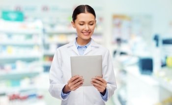 medicine, pharmacy, people, health care and pharmacology concept - smiling female doctor with tablet pc computer over drugstore background