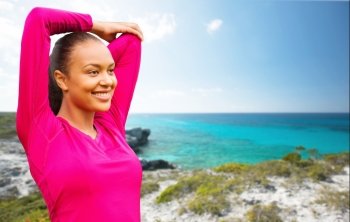 fitness, sport, training, exercising and people concept - smiling woman stretching hand over background