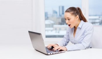 business and office concept - surprised businesswoman using her laptop computer. surprised businesswoman with laptop