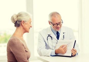medicine, age, health care and people concept - smiling senior woman and doctor meeting in medical office