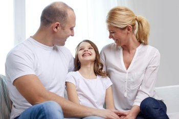 family, children and people concept - happy parents with little daughter at home
