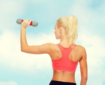 fitness, sport and diet concept - young sporty woman with light dumbbell