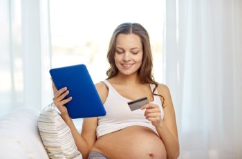 pregnancy, online shopping, technology and people concept - happy pregnant woman with tablet pc computer and credit card at home