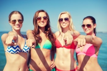 summer vacation, holidays, travel, gesture and people concept - group of happy young women pointing finger on you on beach