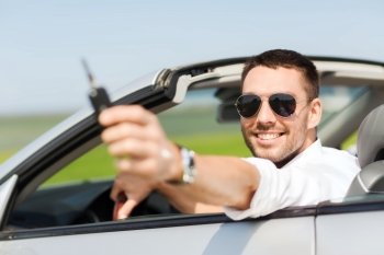 auto business, transport, leisure and people concept - happy man in cabriolet showing car key