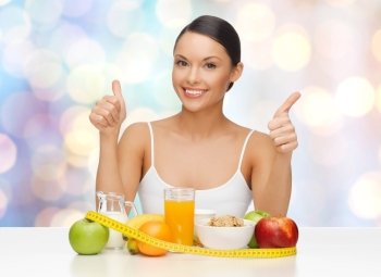 people, gesture and diet concept- happy asian woman with healthy food showing thumbs up over blue lights background