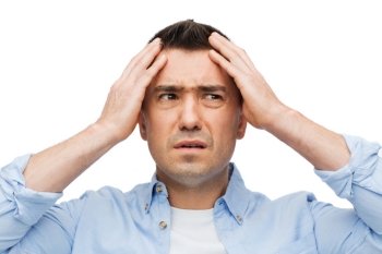 stress, headache, health care and people concept - unhappy man with closed eyes touching his forehead