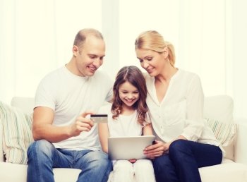 family, child, technology, money and home concept - smiling parents and little girl with tablet pc and credit card at home