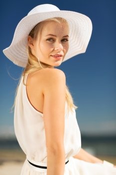 fashion and lifestyle concept - beautiful woman in hat enjoying summer outdoors. beautiful woman enjoying summer outdoors