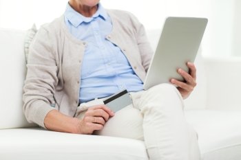 technology, online shopping, age and people concept - close up of senior woman with tablet pc computer and credit or bank card at home