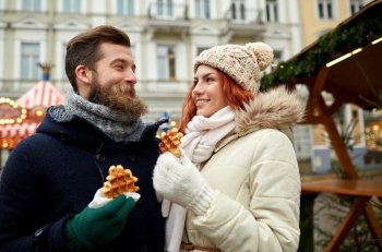 holidays, winter, christmas and people concept - happy couple in warm clothes walking in old town