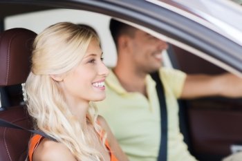 transport, leisure, road trip and people concept - happy man and woman driving car