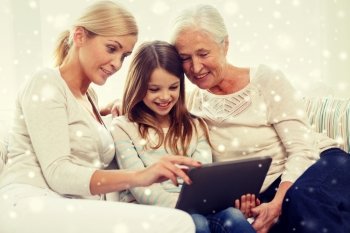 family, generation, technology and people concept - smiling mother, daughter and grandmother with tablet pc computer sitting on couch at home