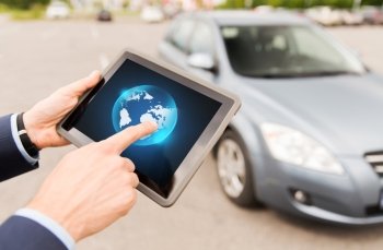 transport, business trip, technology and people concept - close up of male hands with clobe on tablet pc computer screen and car outdoors