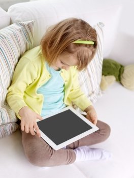 leisure, technology and children concept - little girl with tablet computer at home