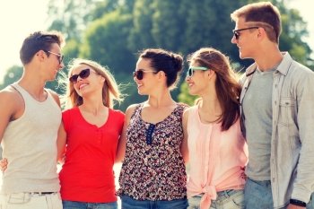 friendship, leisure, summer and people concept - group of smiling friends in city