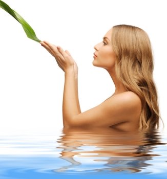 picture of woman with green leaf in water